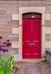 Red door in an old house in Scotland